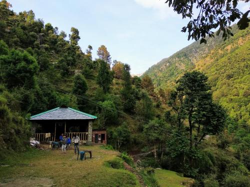a group of people standing in front of a cabin at Ara Camps in McLeod Ganj