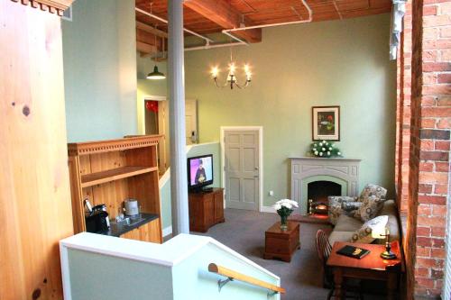 a living room with a couch and a fireplace at The Historic Brookstown Inn, Trademark Collection by Wyndham in Winston-Salem