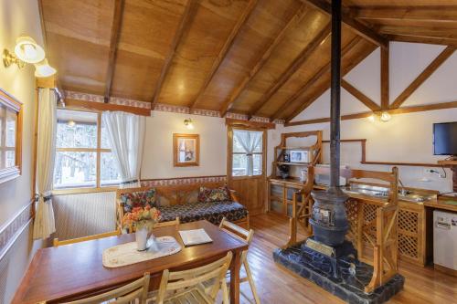 a kitchen and living room with a wood stove at Aldea Nevada in Ushuaia