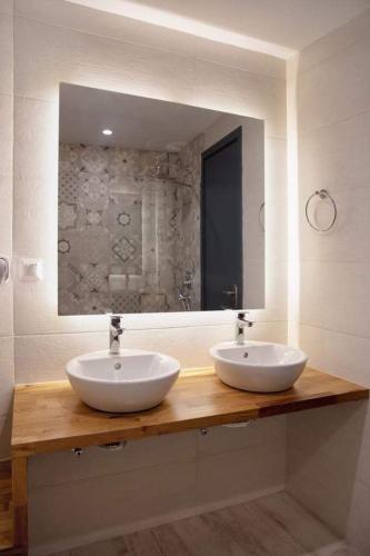 a bathroom with two sinks and a large mirror at Megali Ammos House in Megali Ammos