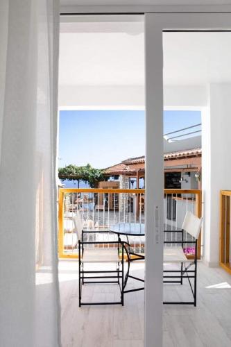 a patio with a table and chairs on a balcony at Megali Ammos House in Megali Ammos
