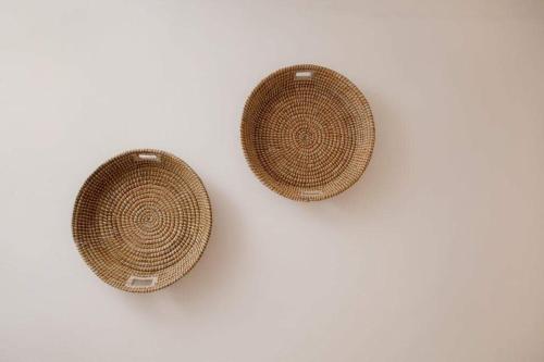 two wicker baskets sitting on a white background at Megali Ammos House in Megali Ammos