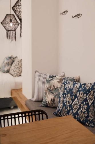 a living room with a couch and pillows at Megali Ammos House in Megali Ammos