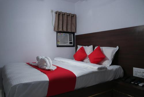 a stuffed animal is sitting on a bed at Hotel Apple Inn in Navi Mumbai
