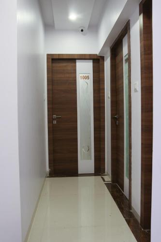 a hallway with a door with the word trolls on it at Hotel Apple Inn in Navi Mumbai