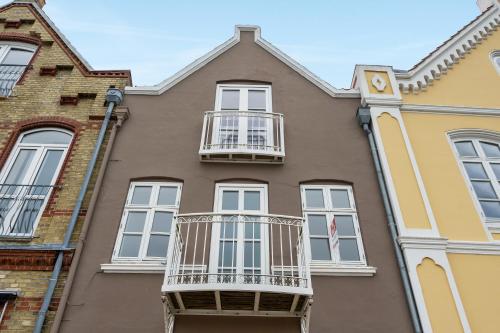 a building with white windows and a balcony at Harbour View in Sønderborg