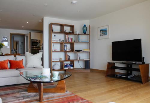 a living room with a couch and a tv at Endcliffe in Falmouth