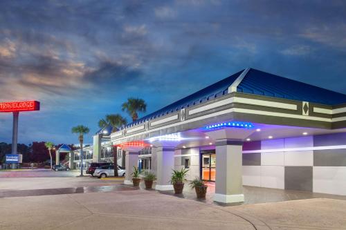 a gas station with a sign in front of it at Travelodge by Wyndham Deltona in Deltona
