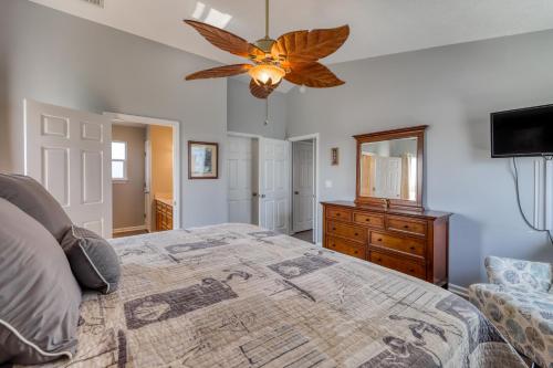 a bedroom with a large bed and a ceiling fan at Tranquil Seas in Saint Joe Beach