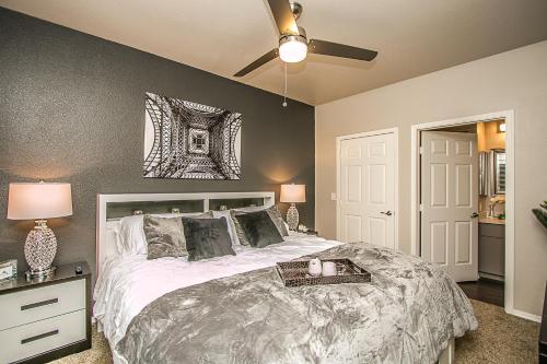 a bedroom with a large bed and a ceiling fan at TPC Golf, Shopping & Dining 3 miles with Parking -1064 in Phoenix