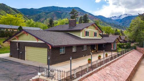 a house with a fence in front of a mountain at INNhale Resort and Spa in Manitou Springs