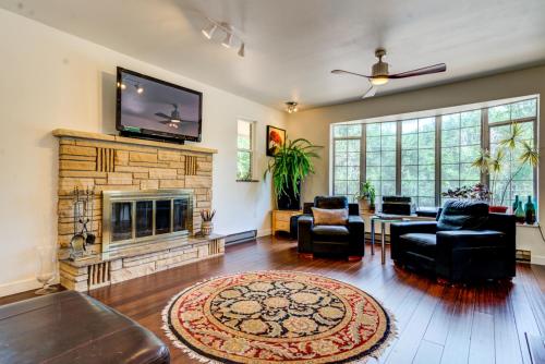 a living room with a fireplace and a flat screen tv at INNhale Resort and Spa in Manitou Springs