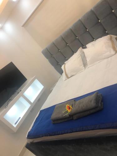 a bedroom with a bed with a towel on it at Verdana Rental Residencial Arlene II SFM in San Francisco de Macorís