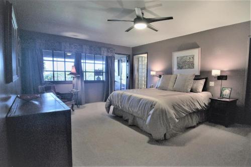 a bedroom with a bed and a ceiling fan at The Inn at Kulaniapia Falls in Hilo