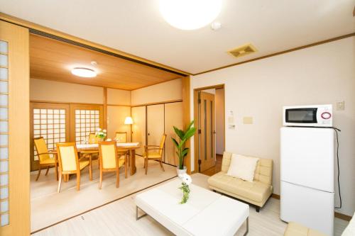 a living room with a kitchen and a dining room at Awaji Seaside Resort in Shiduki1555 in Awaji