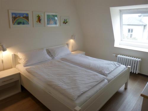 מיטה או מיטות בחדר ב-Haus Therese *FeWo 12*