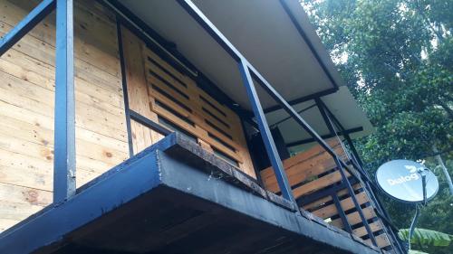 a building with a staircase in front of it at hornbill river cottage udawalwa in Udawalawe