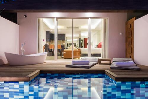 a bathroom with a bath tub and a bath tub at Downtown Villas in Seminyak