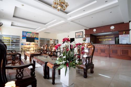 a store with chairs and a table with flowers on it at AD 41 Hotel Huế CS2 in Hue