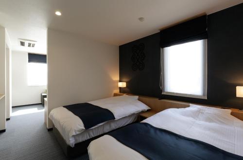 Voodi või voodid majutusasutuse Hotel REUS Ashoro toas