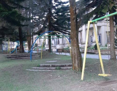 an empty park with a swing set in a park at Villa Berastagi Highland No 8-i in Berastagi