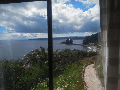 a view of the ocean from a window at Alojha Coliumo Dichato in Coliumo