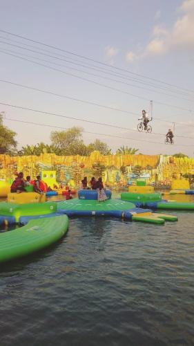 a group of people riding on rafts in the water at Grand Town Hotel Mandai in Makassar