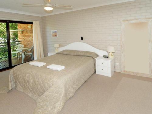 a bedroom with a bed with two towels on it at Illawong 2 in Mooloolaba
