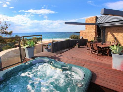 a hot tub on a deck with a view of the beach at Spectacular Location and Views, 3 Bedrooms , Private Rooftop Spa in Mooloolaba