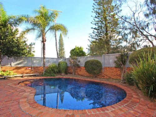 a small swimming pool in a brick yard at Spectacular Location and Views, 3 Bedrooms , Private Rooftop Spa in Mooloolaba