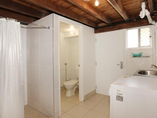 a bathroom with a toilet and a sink at Oloway 40 in Alexandra Headland