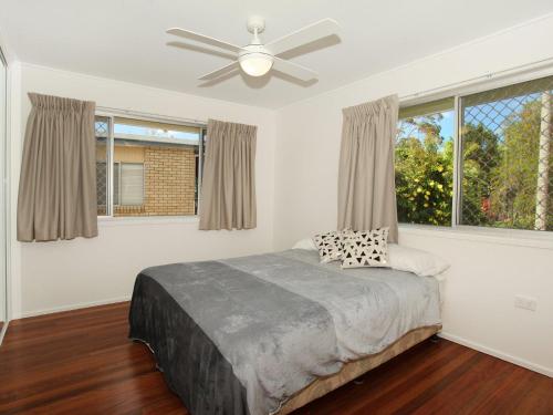a bedroom with a bed and a ceiling fan at Oloway 40 in Alexandra Headland