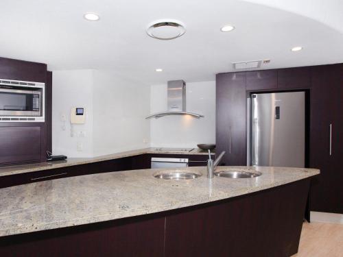 a kitchen with two sinks and a counter top at Sirocco 506 in Mooloolaba