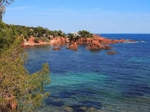 a view of the ocean with rocks in the water at Ibis Budget Fréjus St Raphaël centre in Fréjus