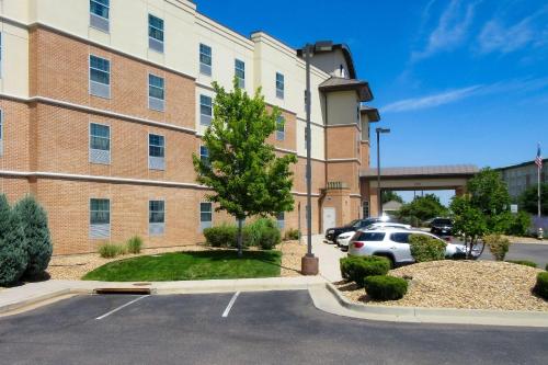 a parking lot in front of a building at Holiday Inn Express & Suites Englewood - Denver South, an IHG Hotel in Englewood