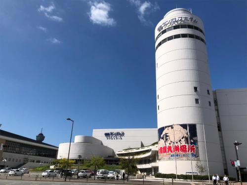a white building with a sign on the side of it at THE HOTELS HAKATA KASANE Bayside in Fukuoka