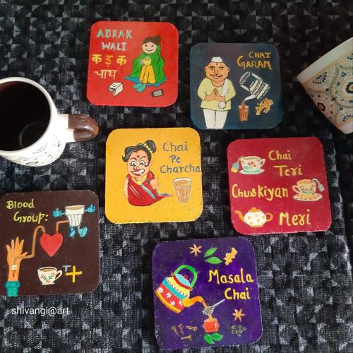 a group of plates with stickers on them with a cup of coffee at Kishan Home Stay in Mathura
