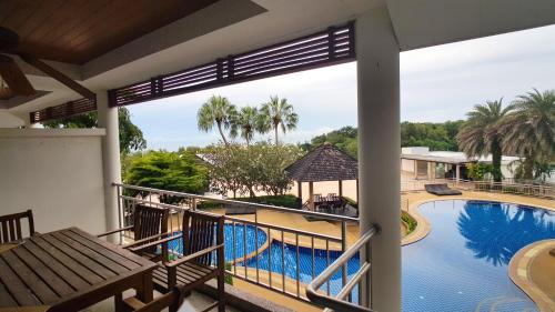 a view from the balcony of a resort with a swimming pool at Spacious apartment with Ocean view in Panwa in Phuket Town