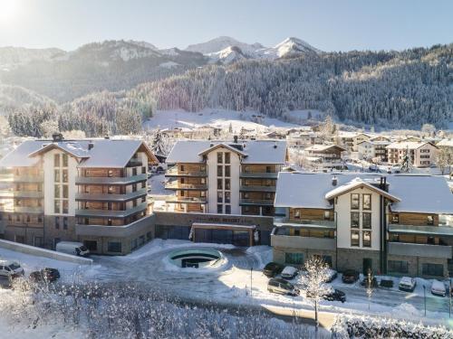 a resort in the mountains in the snow at VAYA Fieberbrunn inklusive Gästekarte in Fieberbrunn
