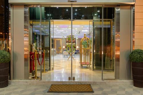 a lobby with a revolving door in a building at Crown Rose Al Sahafa Hotel in Riyadh