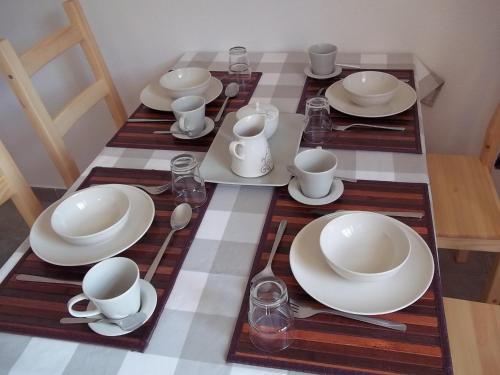 a table with plates and cups and dishes on it at Agriturismo Rio Castello in Marina dʼAndora