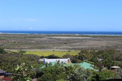 an aerial view of a house and the ocean at 365 Sunset Self Catering Apartments in Noordhoek