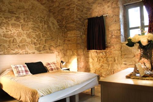 A bed or beds in a room at Al-Hakim Boutique Hotel Old Town Nazareth
