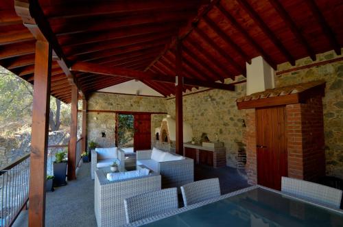 a house with a swimming pool and a patio at To Kastri in Kalopanayiotis