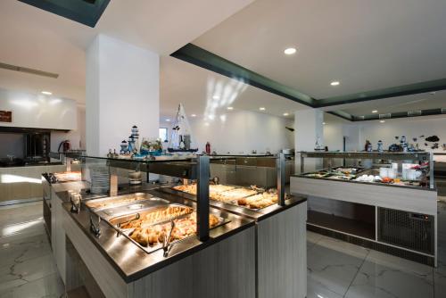 a buffet line with many different types of food at Caretta Paradise Resort & WaterPark in Tragaki