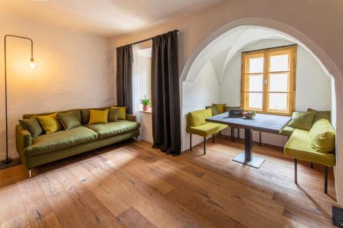 a living room with a couch and a table at Flurin Suites in Glorenza