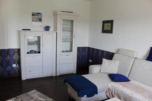 a living room with a couch and a table at Ferienwohnung Ostwind in Schüller