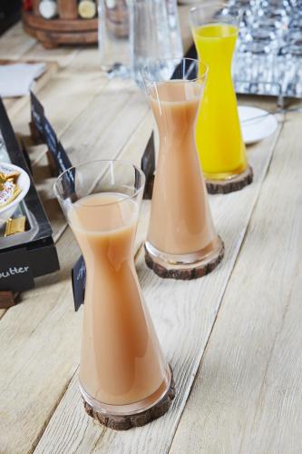two glasses of juice sitting on a wooden table at Prestige Hotel Budapest in Budapest