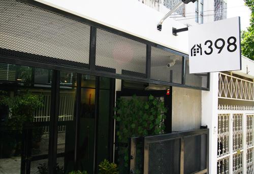a building with a sign in front of it at 398 HOSTEL in Bangkok