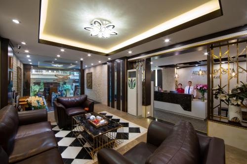 a living room with leather furniture and a lobby at Splendid Star Grand Hotel and Spa in Hanoi